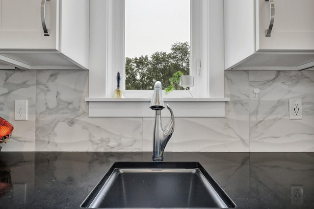 7074 S Ainger Rd, Olivet, MI 49076 - kitchen view of white cabinets, tasteful backsplash, and dark stone countertops