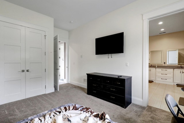 7074 S Ainger Rd, Olivet, MI 49076 - bedroom featuring light carpet, a closet, connected bathroom, and recessed lighting