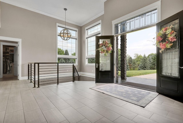 7074 S Ainger Rd, Olivet, MI 49076 - foyer entrance with a chandelier, ornamental molding, and a high ceiling