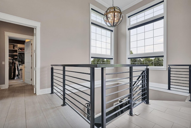 7074 S Ainger Rd, Olivet, MI 49076 - staircase with a chandelier, plenty of natural light, and ornamental molding