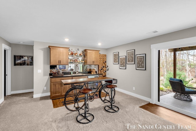17947 Spring Tree Ct, Spring Lake, MI 49456 - kitchen with dark countertops, light carpet, and recessed lighting