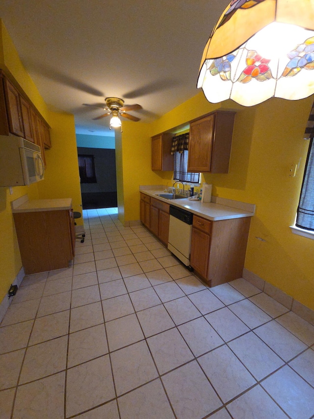 20041 Village Green Ct Unit 14, Brownstown, MI 48183 - kitchen featuring white appliances, light countertops, brown cabinetry, light tile patterned flooring, and ceiling fan