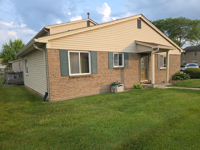 20041 Village Green Ct Unit 14, Brownstown, MI 48183 - view of front of house featuring a front lawn and brick siding