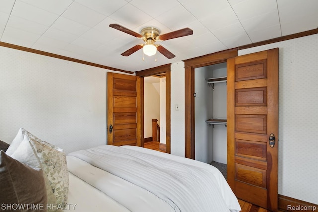 34 Charles St, Hillsdale, MI 49242 - bedroom with ornamental molding, wallpapered walls, a closet, and ceiling fan