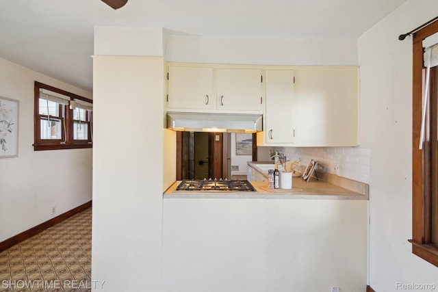 34 Charles St, Hillsdale, MI 49242 - kitchen with extractor fan, tile patterned floors, tasteful backsplash, cream cabinets, and light countertops
