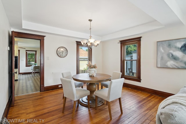 34 Charles St, Hillsdale, MI 49242 - dining room with a raised ceiling, a chandelier, and light wood-style flooring