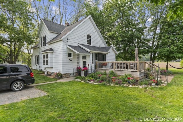 3665 47th St, Hamilton, MI 49419 - view of front facade featuring roof with shingles, a wooden deck, a front lawn, and a chimney