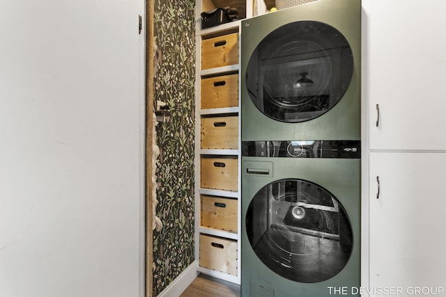 3665 47th St, Hamilton, MI 49419 - laundry area with stacked washing machine and dryer and wood finished floors