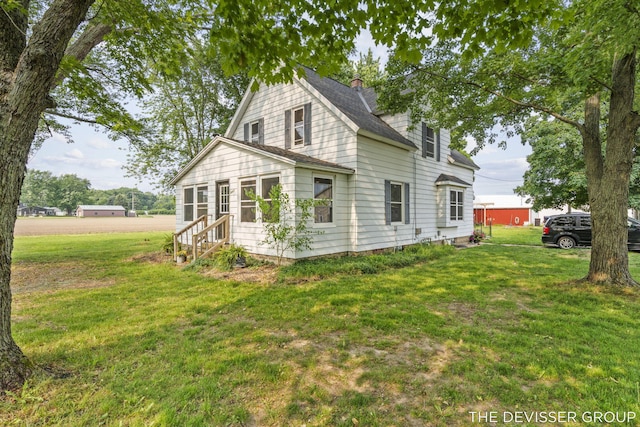 3665 47th St, Hamilton, MI 49419 - view of front of home with entry steps, a front yard, a chimney, and a shingled roof