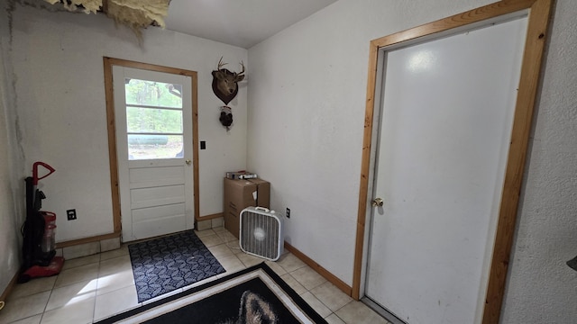 211 Skocelas Rd N, Manistee, MI 49660 - doorway to outside with light tile patterned floors and baseboards