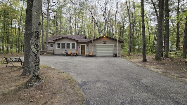 211 Skocelas Rd N, Manistee, MI 49660 - view of front of home with an attached garage and asphalt driveway