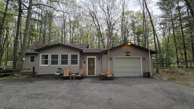 211 Skocelas Rd N, Manistee, MI 49660 - view of front of house with a garage, asphalt driveway, and a shingled roof