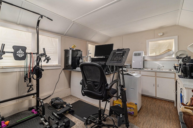 724 E Ludington Ave, Ludington, MI 49431 - workout area featuring vaulted ceiling and dark wood finished floors