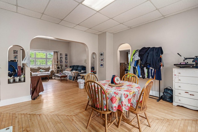 724 E Ludington Ave, Ludington, MI 49431 - dining room featuring arched walkways, hardwood / wood-style flooring, and a paneled ceiling