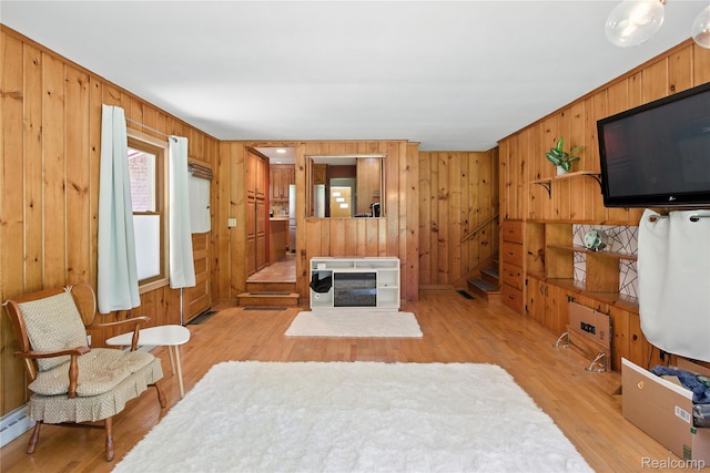 2329 Cumberland Rd, Lansing, MI 48906 - living area featuring wood walls and light wood-style flooring