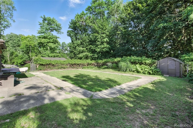 2329 Cumberland Rd, Lansing, MI 48906 - view of grassy yard featuring a storage shed