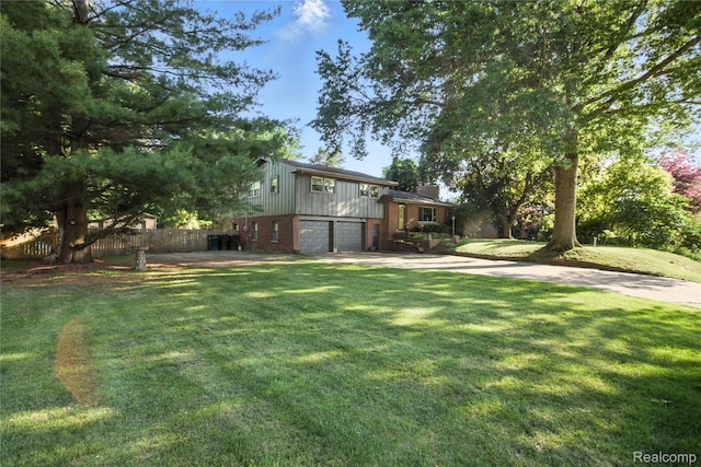 2329 Cumberland Rd, Lansing, MI 48906 - view of yard with driveway and a garage
