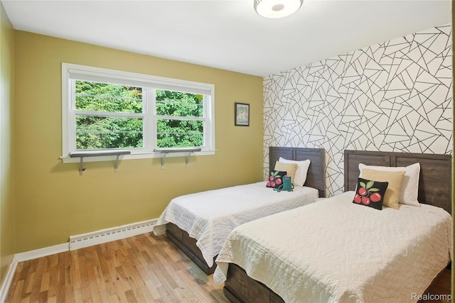 2329 Cumberland Rd, Lansing, MI 48906 - bedroom featuring a baseboard heating unit and wood finished floors