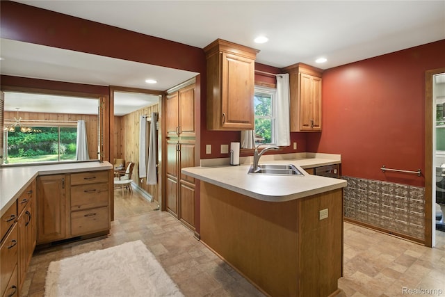 2329 Cumberland Rd, Lansing, MI 48906 - kitchen with light countertops, stone finish flooring, a peninsula, healthy amount of natural light, and recessed lighting
