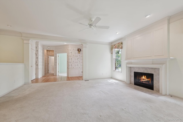 1921 Dunham Dr, Rochester, MI 48306 - unfurnished living room featuring light colored carpet, a fireplace, crown molding, a ceiling fan, and decorative columns