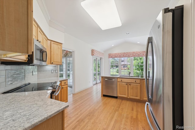 1921 Dunham Dr, Rochester, MI 48306 - kitchen featuring appliances with stainless steel finishes, vaulted ceiling, light countertops, light wood-style flooring, and decorative backsplash