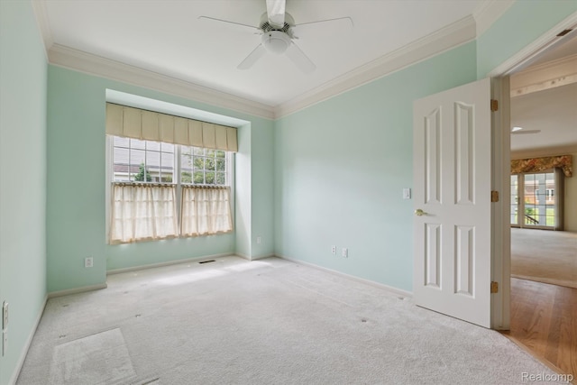 1921 Dunham Dr, Rochester, MI 48306 - spare room featuring carpet floors, crown molding, ceiling fan, and plenty of natural light