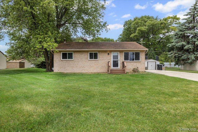 12115 Newburgh Rd, Livonia, MI 48150 - view of front of house with brick siding, a storage unit, and a front yard