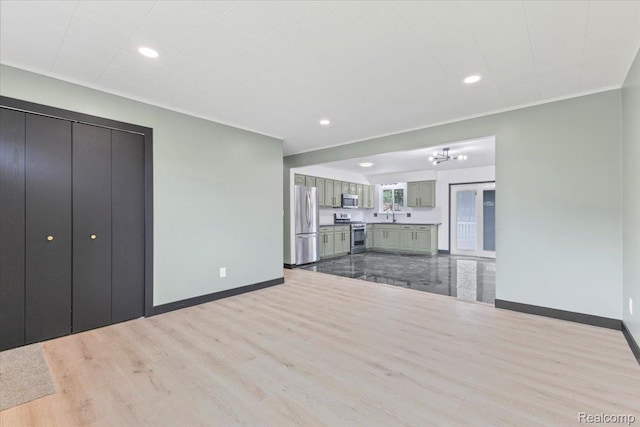 12115 Newburgh Rd, Livonia, MI 48150 - unfurnished living room featuring wood finished floors, recessed lighting, and a chandelier