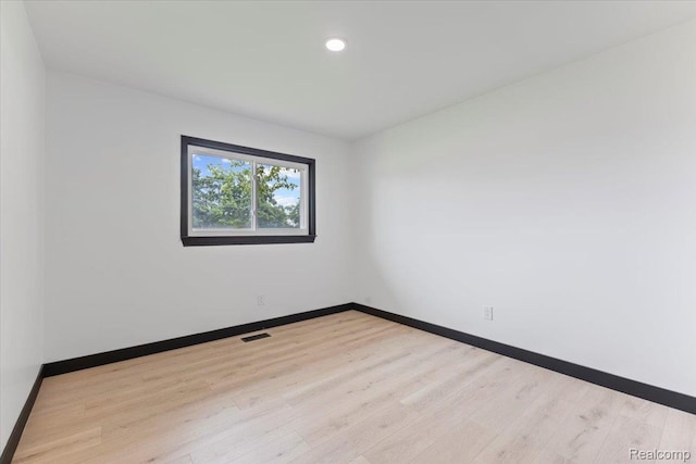 12115 Newburgh Rd, Livonia, MI 48150 - spare room with wood finished floors and recessed lighting