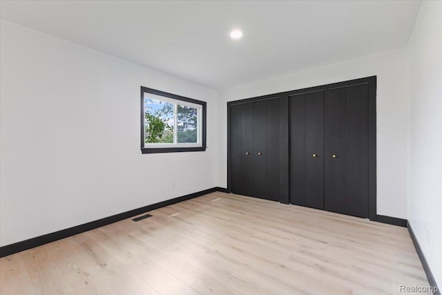 12115 Newburgh Rd, Livonia, MI 48150 - unfurnished bedroom featuring light wood-type flooring and baseboards
