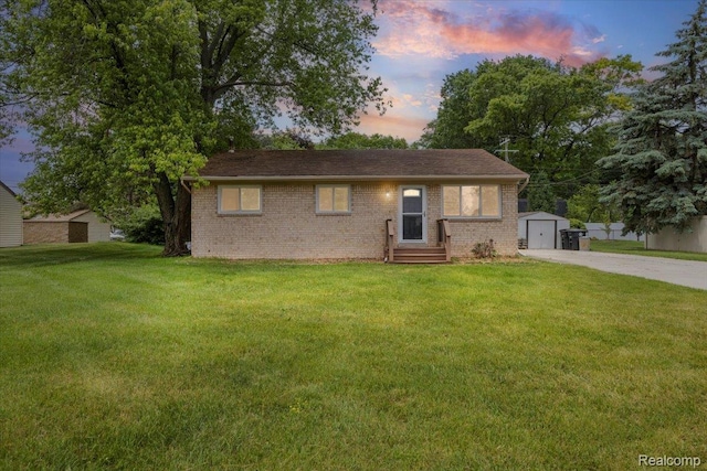 12115 Newburgh Rd, Livonia, MI 48150 - view of front of house with brick siding, a storage shed, a yard, and concrete driveway