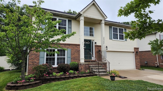 29390 Juniper St, Trenton, MI 48183 - view of front of home featuring brick siding, driveway, a garage, and a front lawn