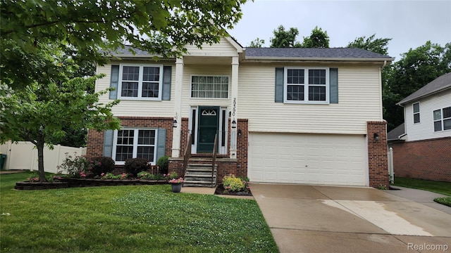 29390 Juniper St, Trenton, MI 48183 - raised ranch with brick siding, an attached garage, and driveway