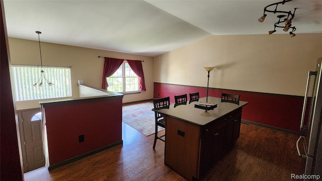 29390 Juniper St, Trenton, MI 48183 - kitchen featuring a kitchen island, a breakfast bar, dark wood-type flooring, and lofted ceiling