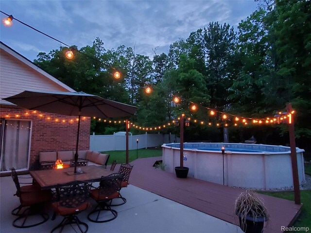 29390 Juniper St, Trenton, MI 48183 - view of patio featuring a deck, outdoor dining space, and a fire pit