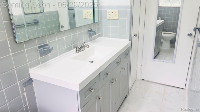 23930 Eureka Ave, Warren, MI 48091 - bathroom featuring tile walls, vanity, and decorative backsplash