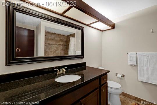 7190 Pebble Park Dr, West Bloomfield, MI 48322 - full bath with vanity, tile patterned floors, and a shower with shower curtain