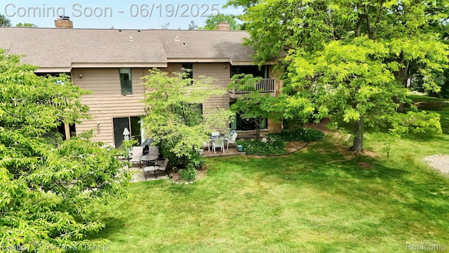 7190 Pebble Park Dr, West Bloomfield, MI 48322 - rear view of property with a patio, a chimney, a yard, and roof with shingles