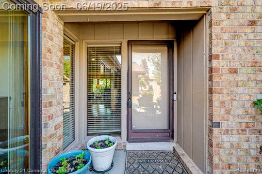 7190 Pebble Park Dr, West Bloomfield, MI 48322 - entrance to property with brick siding and board and batten siding