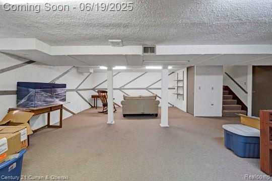 7190 Pebble Park Dr, West Bloomfield, MI 48322 - finished below grade area with stairway, a textured ceiling, and carpet floors