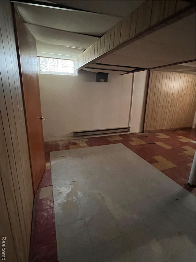 21421 Bournemouth St, Taylor, MI 48225 - below grade area with baseboard heating, tile patterned floors, and wood walls
