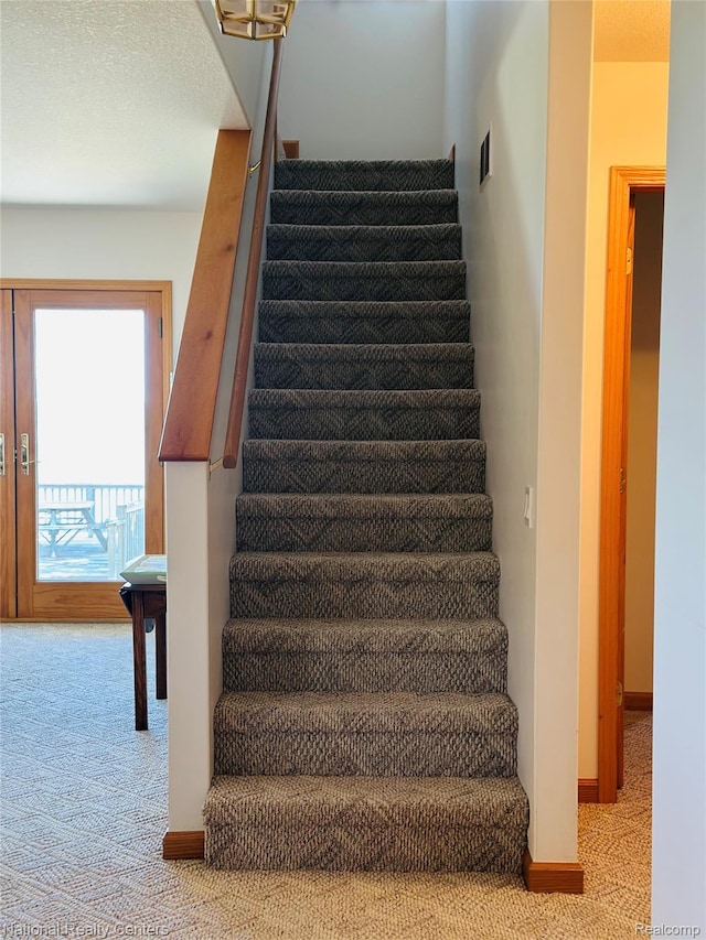 1390 N US-23, East Tawas, MI 48730 - stairway featuring carpet floors