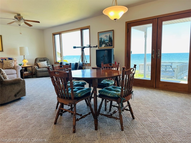 1390 N US-23, East Tawas, MI 48730 - dining space with light carpet, a ceiling fan, and french doors