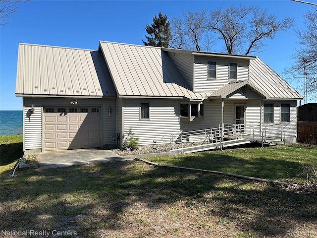 1390 N US-23, East Tawas, MI 48730 - rear view of property featuring a metal roof, a garage, and a lawn