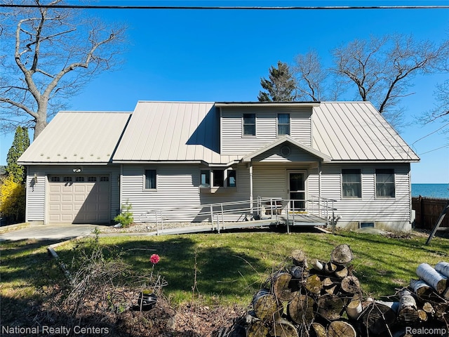 1390 N US-23, East Tawas, MI 48730 - rear view of house with an attached garage and a metal roof