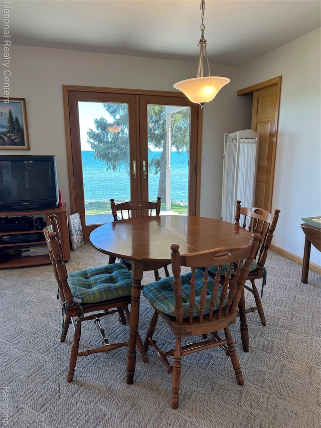 1390 N US-23, East Tawas, MI 48730 - dining area with light colored carpet and french doors