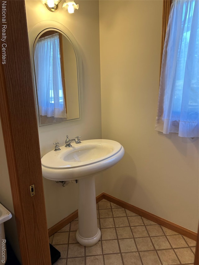1390 N US-23, East Tawas, MI 48730 - half bath with tile patterned flooring and baseboards