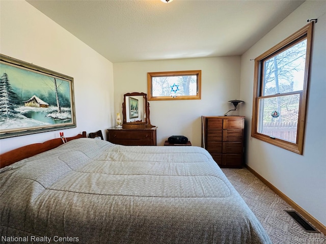 1390 N US-23, East Tawas, MI 48730 - carpeted bedroom featuring multiple windows