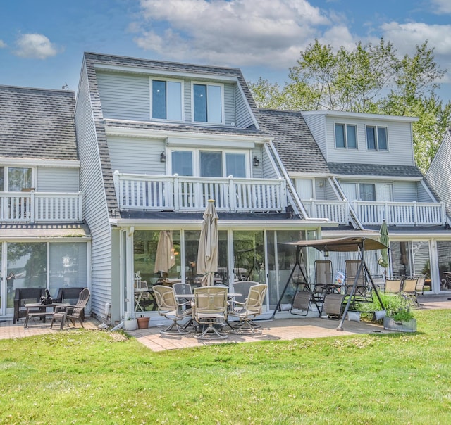 61626 Colony Bay Dr Unit 15, Cassopolis, MI 49031 - rear view of house with a balcony, a patio area, a lawn, and roof with shingles