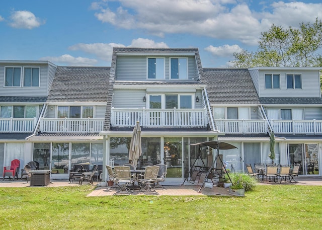 61626 Colony Bay Dr Unit 15, Cassopolis, MI 49031 - rear view of property featuring a balcony, a lawn, a shingled roof, and a patio area